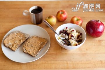 飲食,室內(nèi),湯匙,盤子,碗_122362397_A top down view of a healthy breakfast bowl of cranberries, almonds, Greek yogurt and bananas, also apples, toast with peanut butter and a cup of coffee._創(chuàng)意圖片_Getty Images China